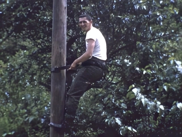 Kinnes climbing a telephone pole