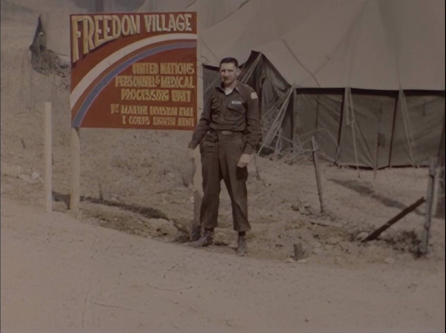 Kinnes at the Freedom Village sign